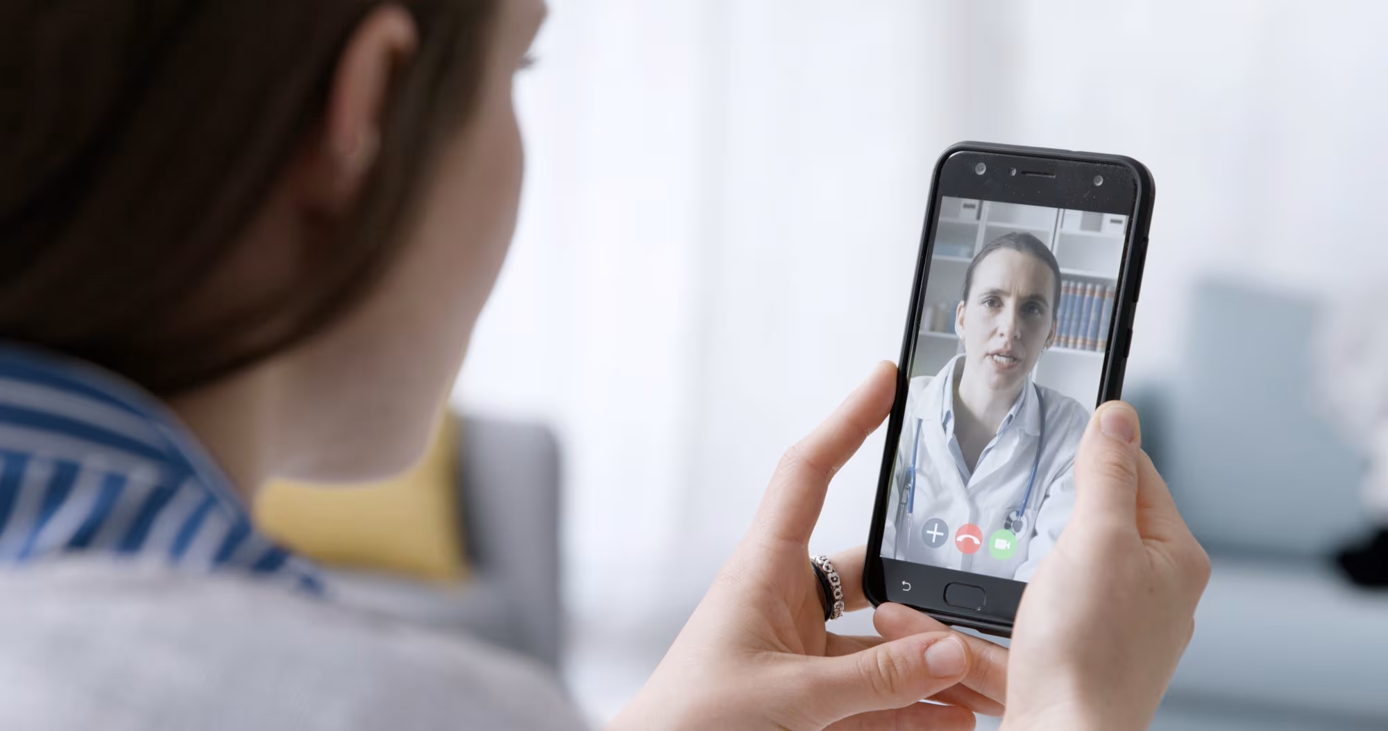 Woman video calling her online doctor